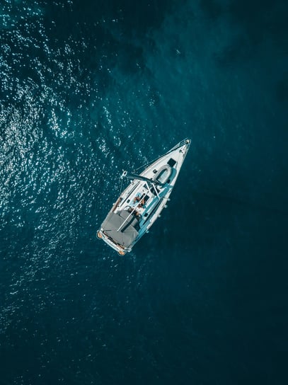 Bird’s-eye view of a yacht in open water, reflecting perspective, freedom and confident direction