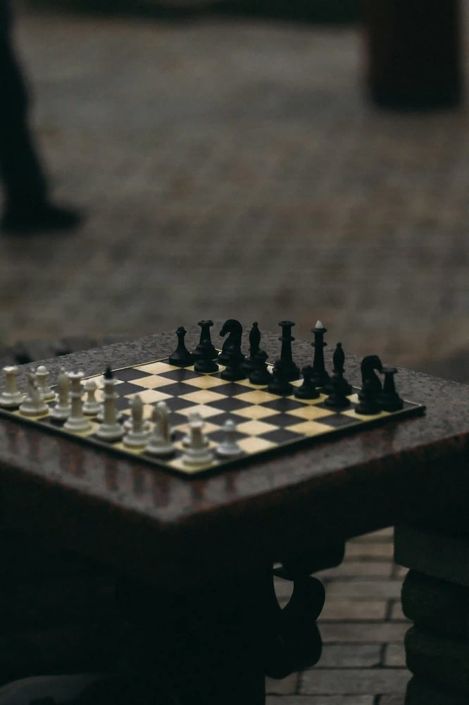 Classic chessboard in a street setting, reflecting strategy, focus and thoughtful decision-making