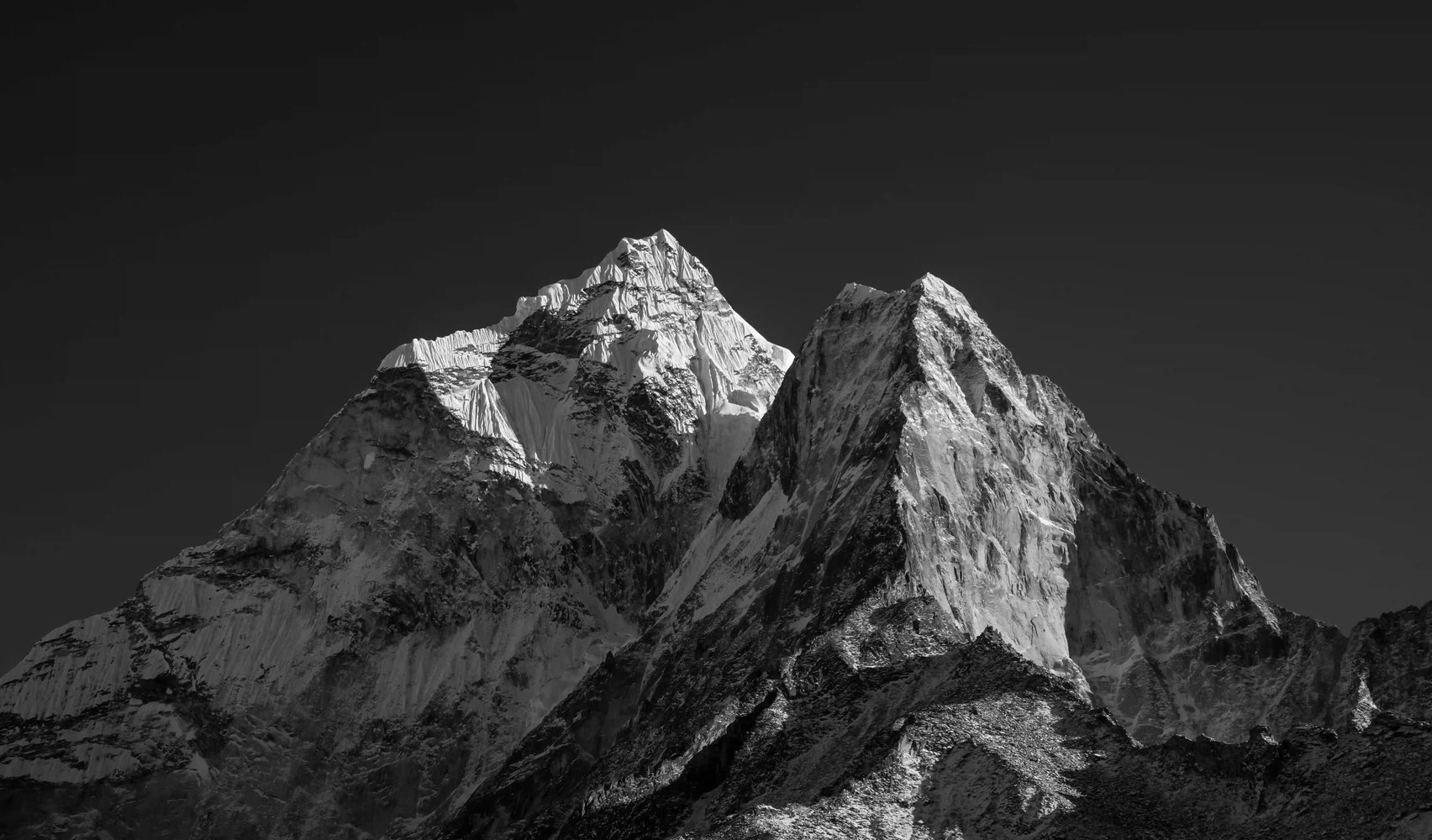 Dramatic black and white snow-covered mountain tops, reflecting resilience, perspective and long-term stability