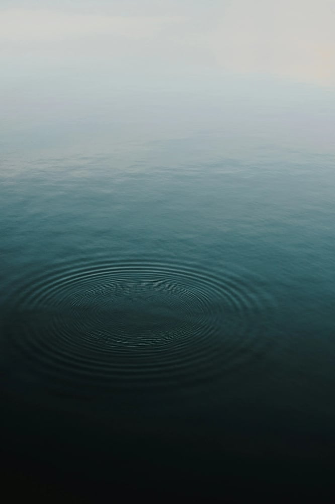 Gentle ripples in open blue water, reflecting calm, clarity and steady focus