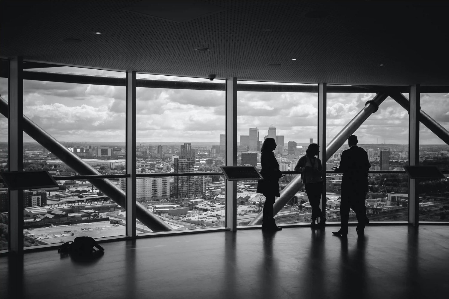 office-workers-meet-at-window-overlooking-city
