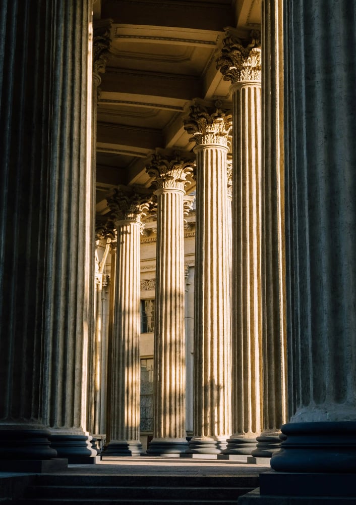 ornate-stone-columns-in-dappled-sunlight