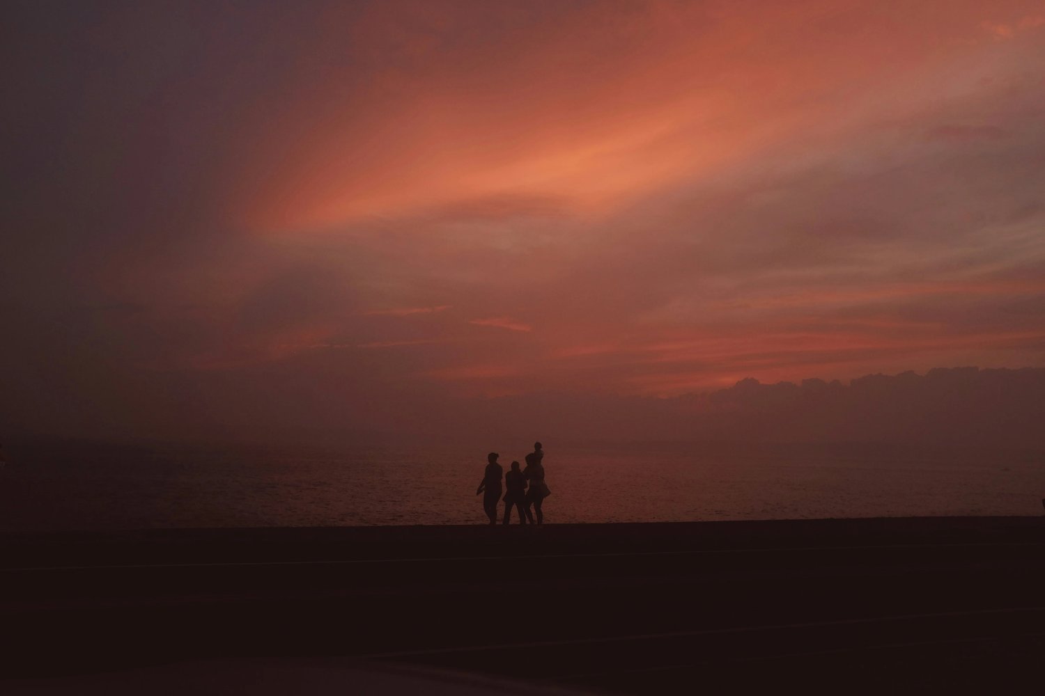 Family walking along a beach at sunset, reflecting connection, wellbeing and long-term security