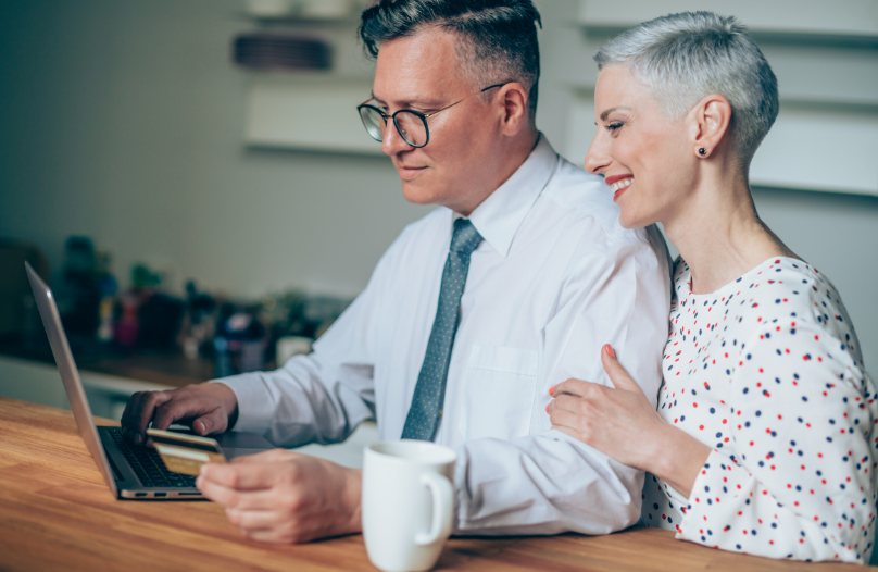 A couple using a compound interest calculator.